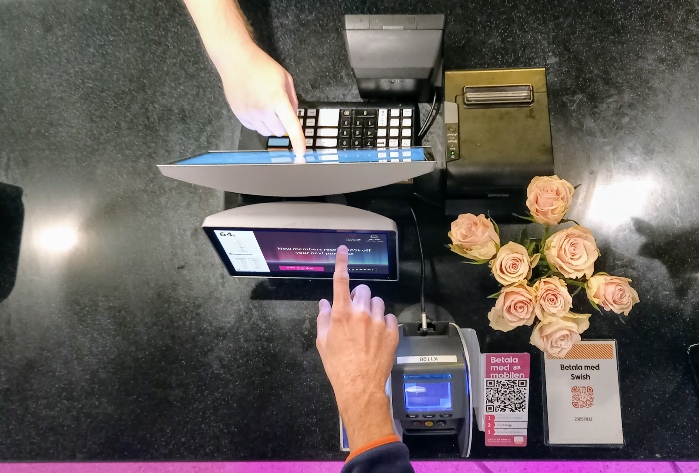 Two users interacting with two touch displays at the same time.